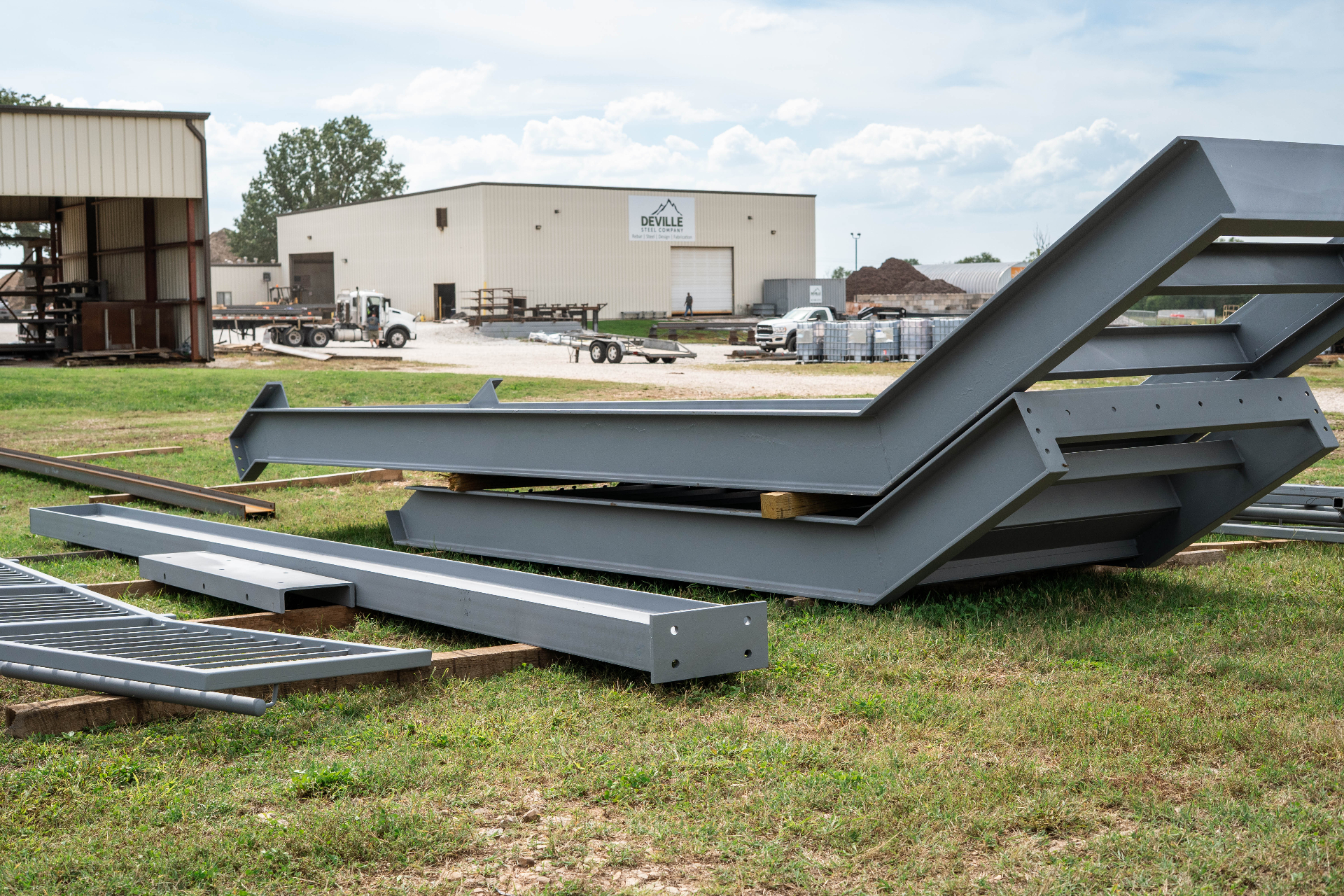 Fabricated structural steel framing staged in front of the DeVille shop