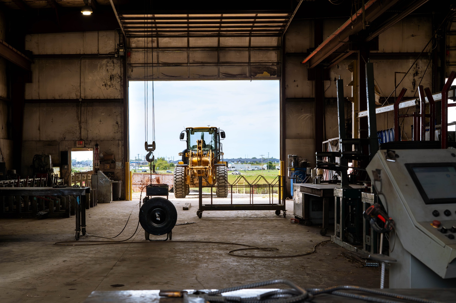 View from inside the DeVille shop out to a wheel loader in the yard